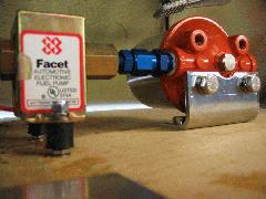 Closeup of Fram HPG-1 with its 3/8NPT male-to-AN male adapter attached to an AN female-to-1/8NPT into the Facet pump. Note rubber vibration mount (from Wicks) of the Facet also positions fittings properly. IMG_0401.jpg